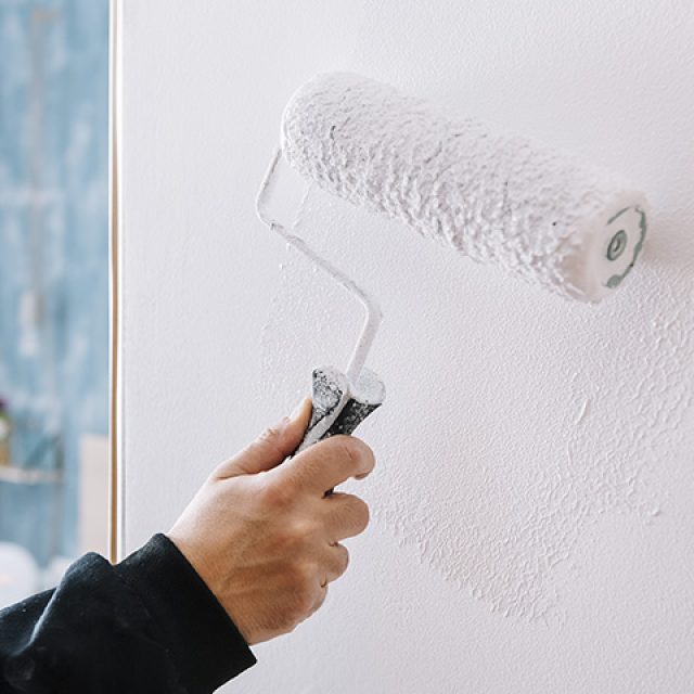 Tenerife Facility professional painting a wall.